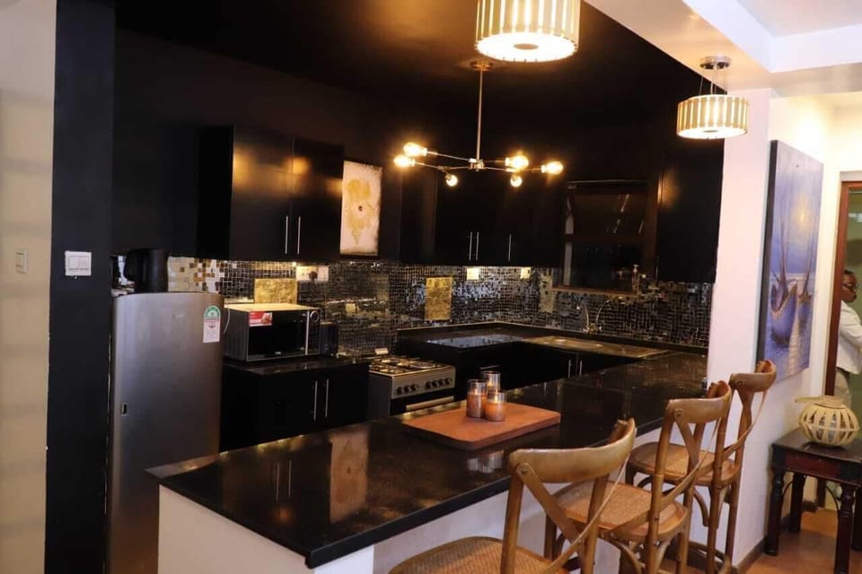 Deluxe Apartment, City View | Private kitchen | Microwave, cookware/dishes/utensils, dining tables