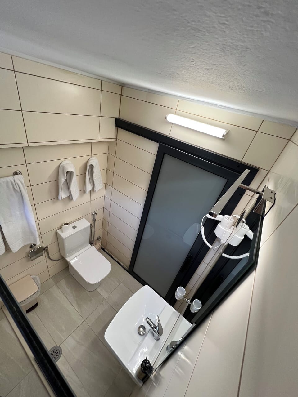 Shower, hair dryer, slippers, towels