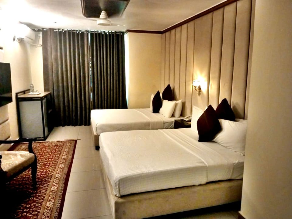 Deluxe Quadruple Room, City View | Desk, laptop workspace, soundproofing, free WiFi