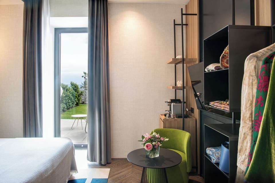 Deluxe Double Room, Patio, Sea View | Minibar, in-room safe, blackout drapes, soundproofing