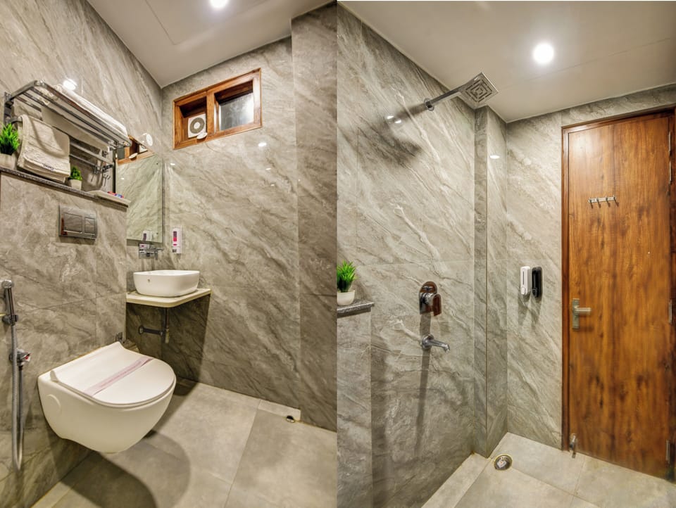 Shower, designer toiletries, slippers, towels