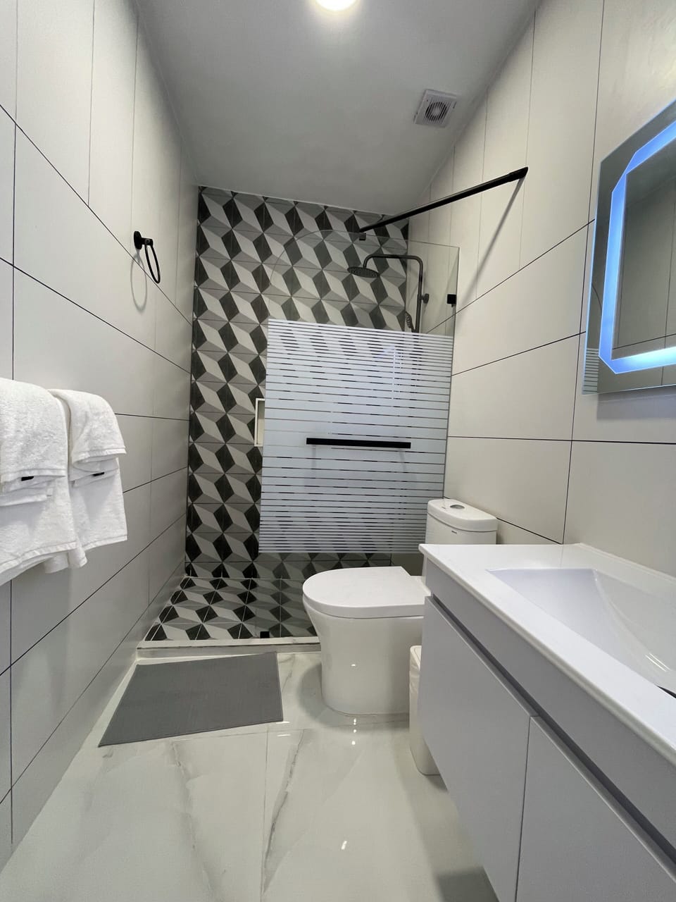 Shower, rainfall showerhead, hair dryer, towels