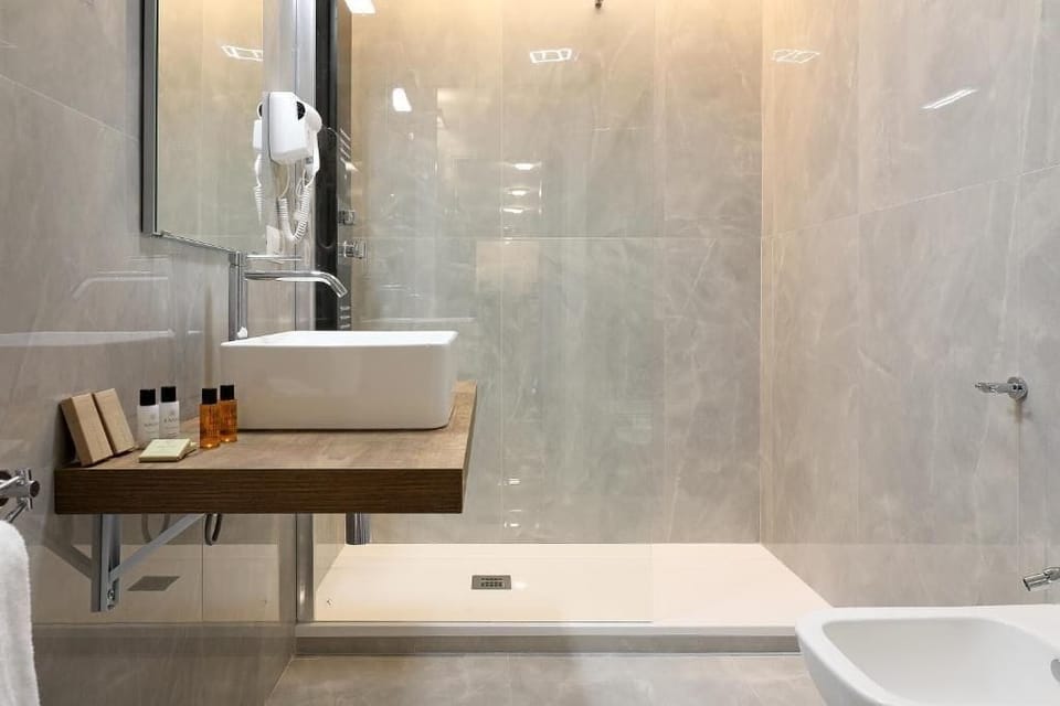 Designer toiletries, hair dryer, slippers, bidet