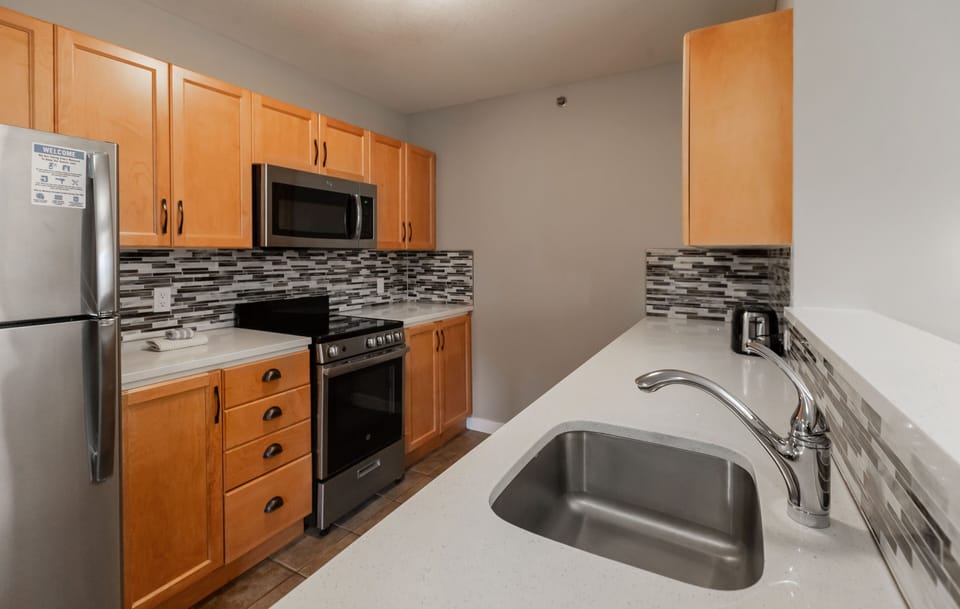 Village Suites Two Bedroom with Kitchen | Private kitchen | Microwave, coffee/tea maker, electric kettle, toaster