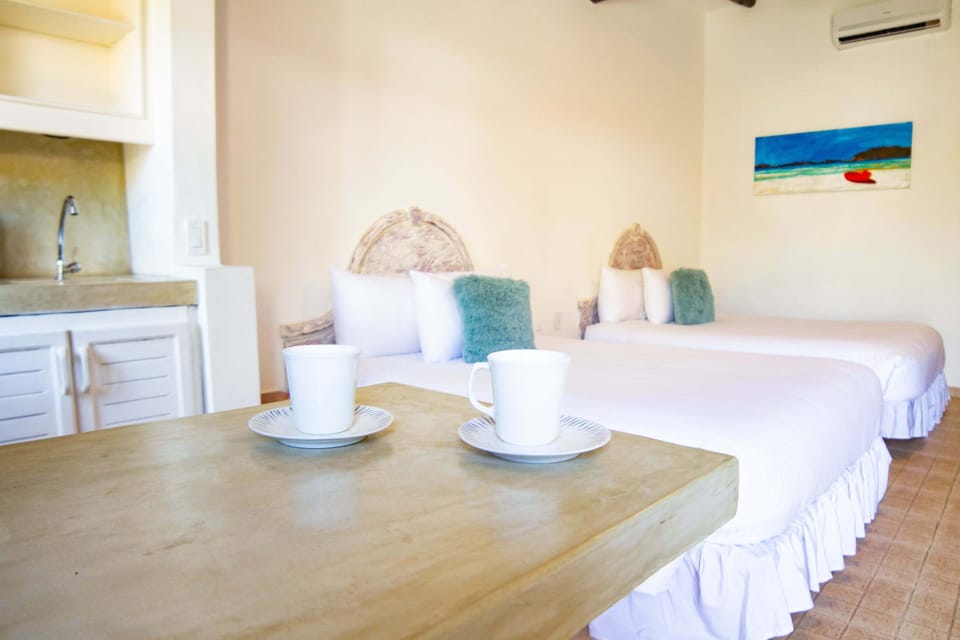 Standard Quadruple Room, Pool View | Minibar, in-room safe, desk, laptop workspace