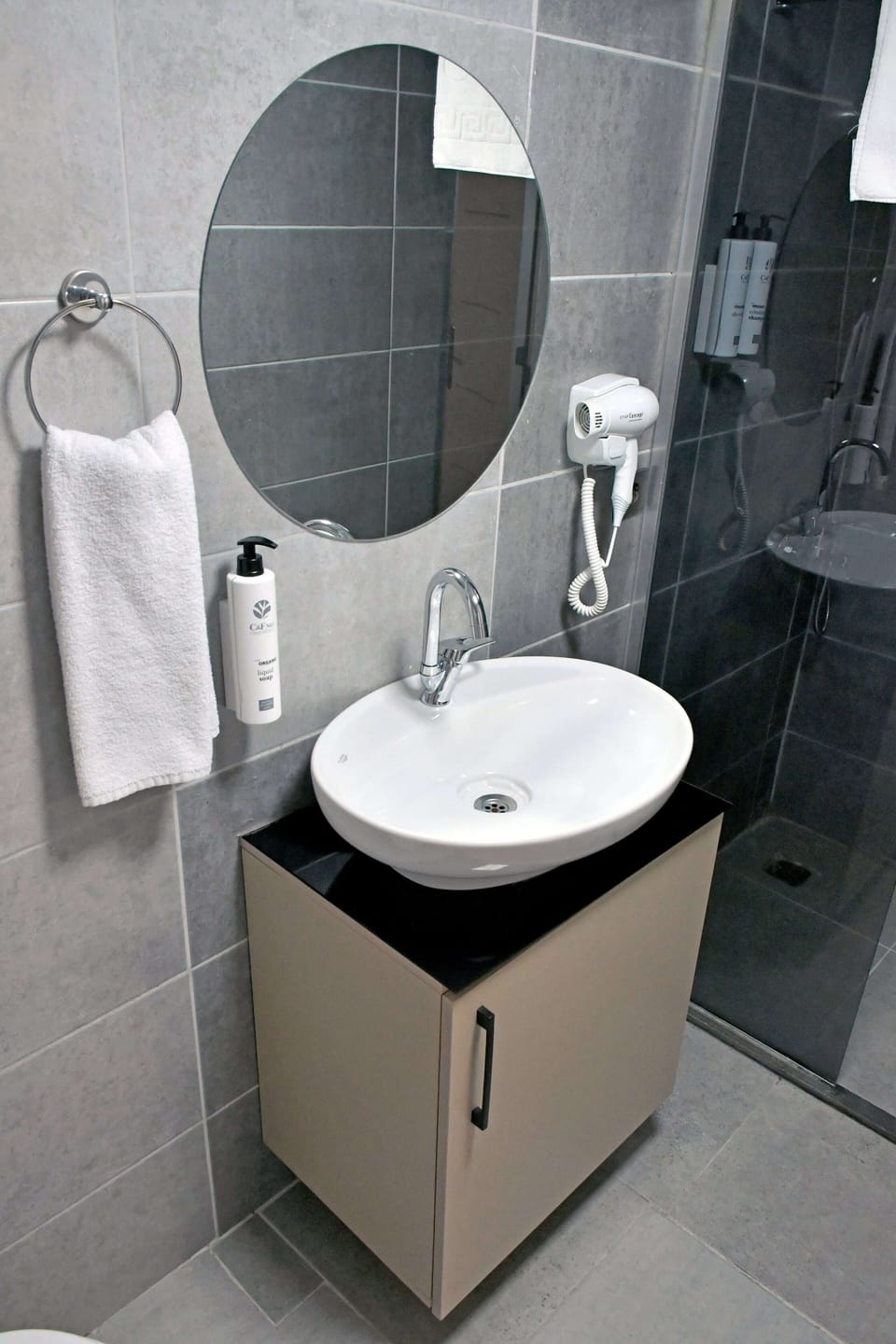 Shower, hair dryer, slippers, towels