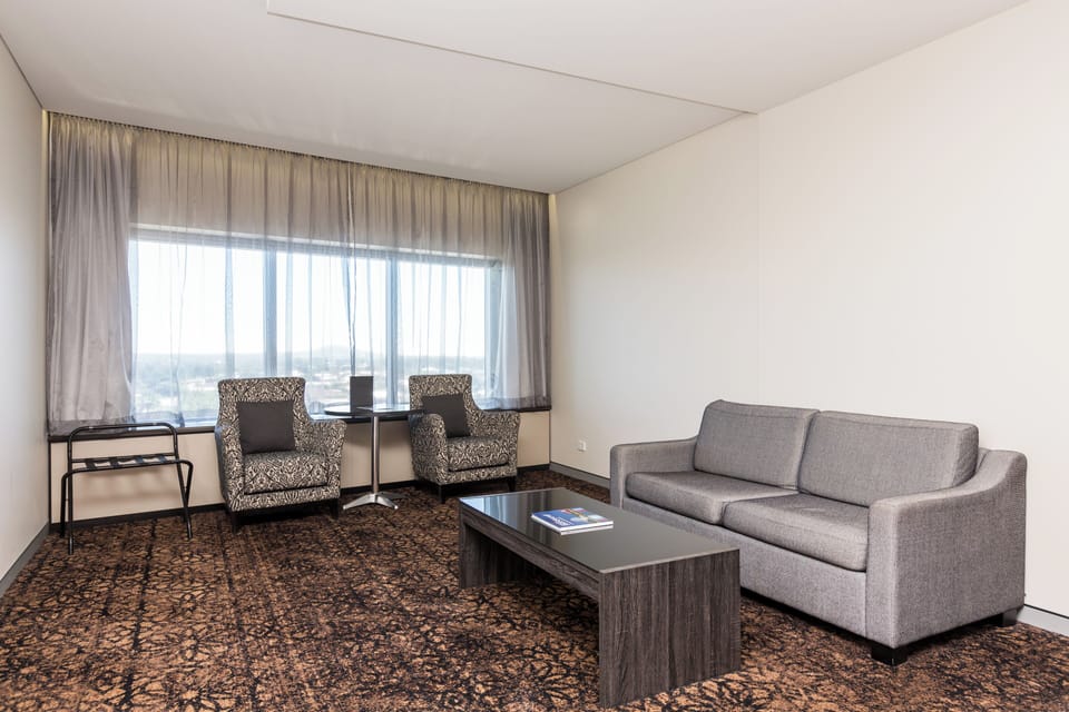 Executive Suite, 1 King Bed | Living area | 34-inch LED TV with cable channels, TV, pay movies