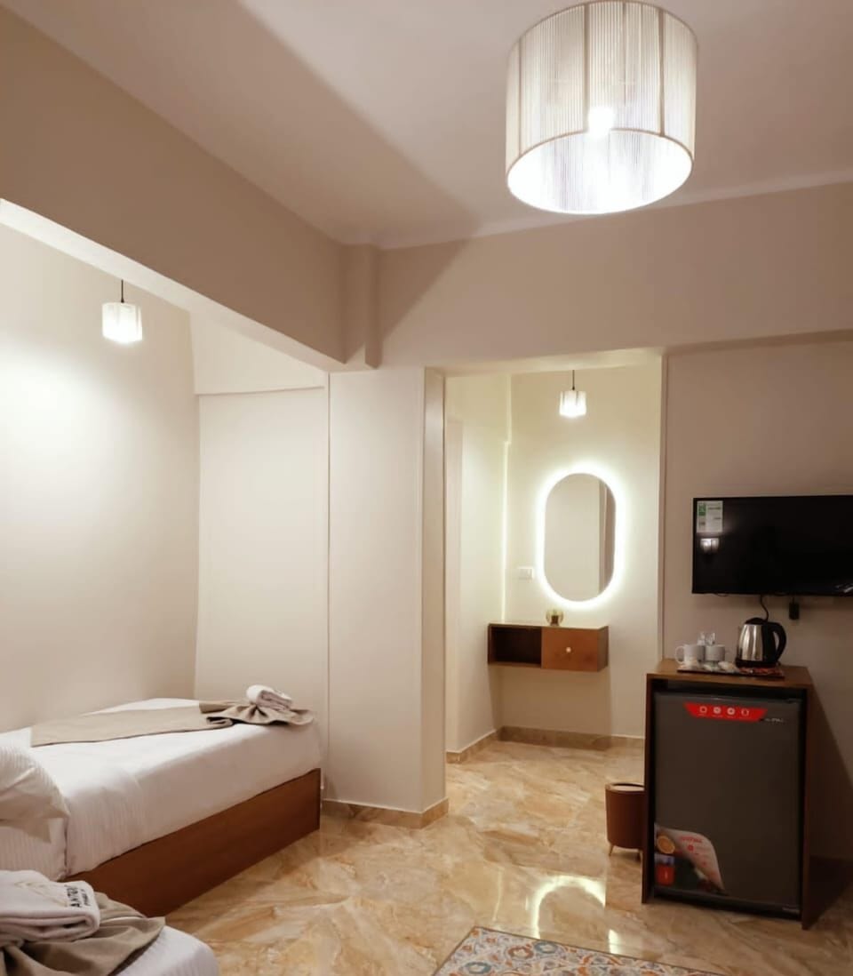 Luxury Triple Room, Multiple Beds, Non Smoking, Private Bathroom | Minibar, desk, soundproofing, iron/ironing board