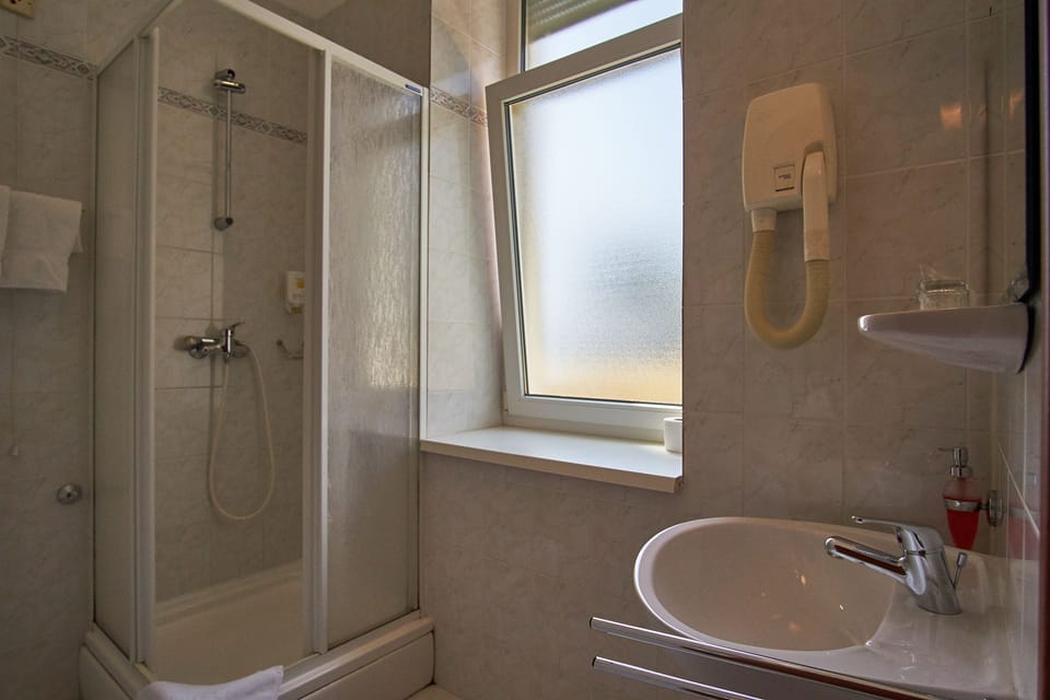 Double Room, Courtyard Area | Bathroom | Shower, hair dryer, towels