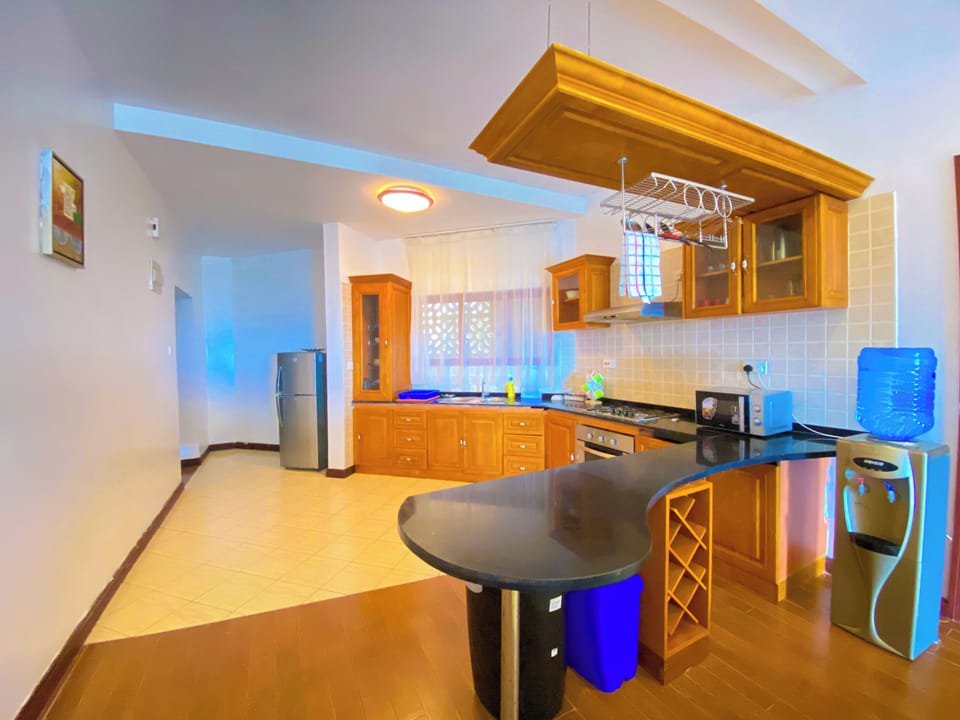 Deluxe Apartment, Partial Ocean View | Private kitchen | Fridge, microwave, oven, stovetop
