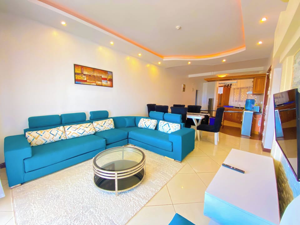 Deluxe Apartment, Partial Ocean View | Living area | Flat-screen TV