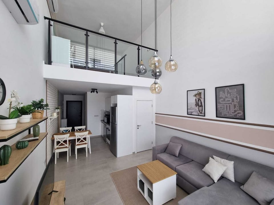Deluxe Duplex, Balcony, Pool View | Living area | 40-inch flat-screen TV with satellite channels