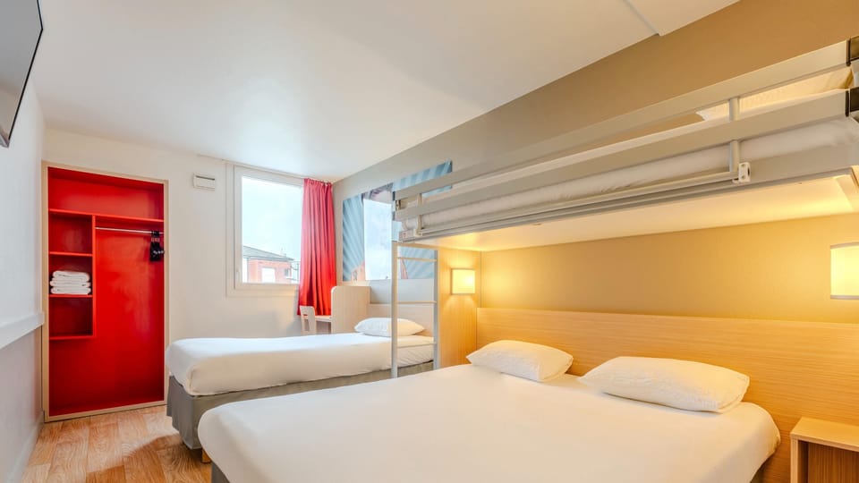 Premium bedding, desk, laptop workspace, blackout drapes
