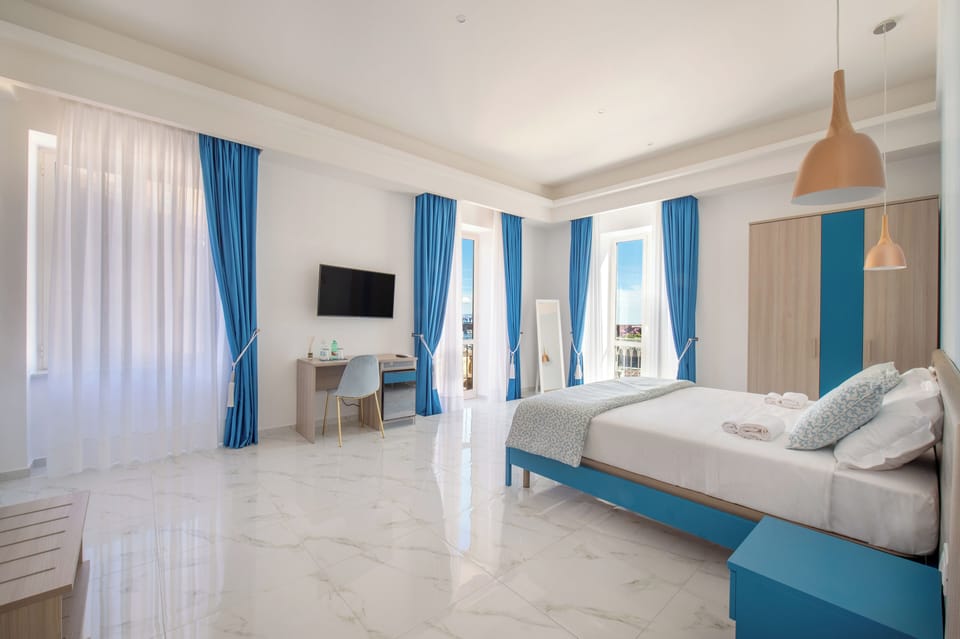 Exclusive Suite, Balcony, Sea View | Minibar, in-room safe, laptop workspace, blackout drapes