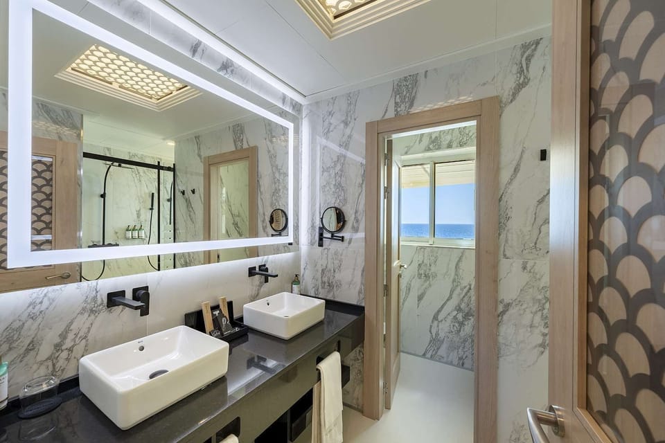 Suite, Sea View | Bathroom | Rainfall showerhead, free toiletries, hair dryer, bathrobes