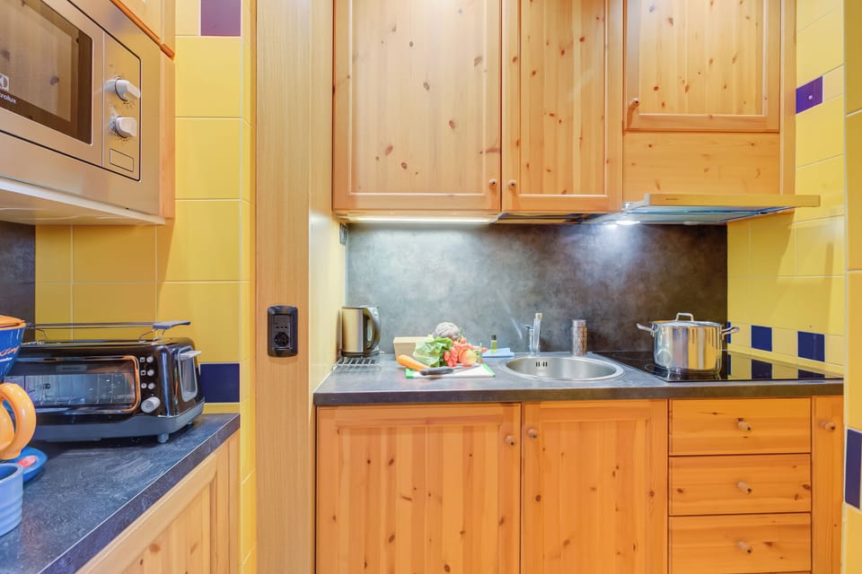 Family Apartment, Multiple Bedrooms (Giglio) | Private kitchen | Microwave, stovetop, coffee/tea maker, electric kettle