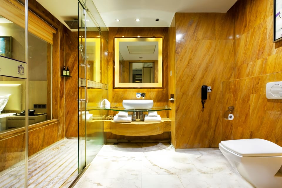 Luxury Suite, 1 King Bed | Bathroom | Rainfall showerhead, eco-friendly toiletries, hair dryer, bathrobes