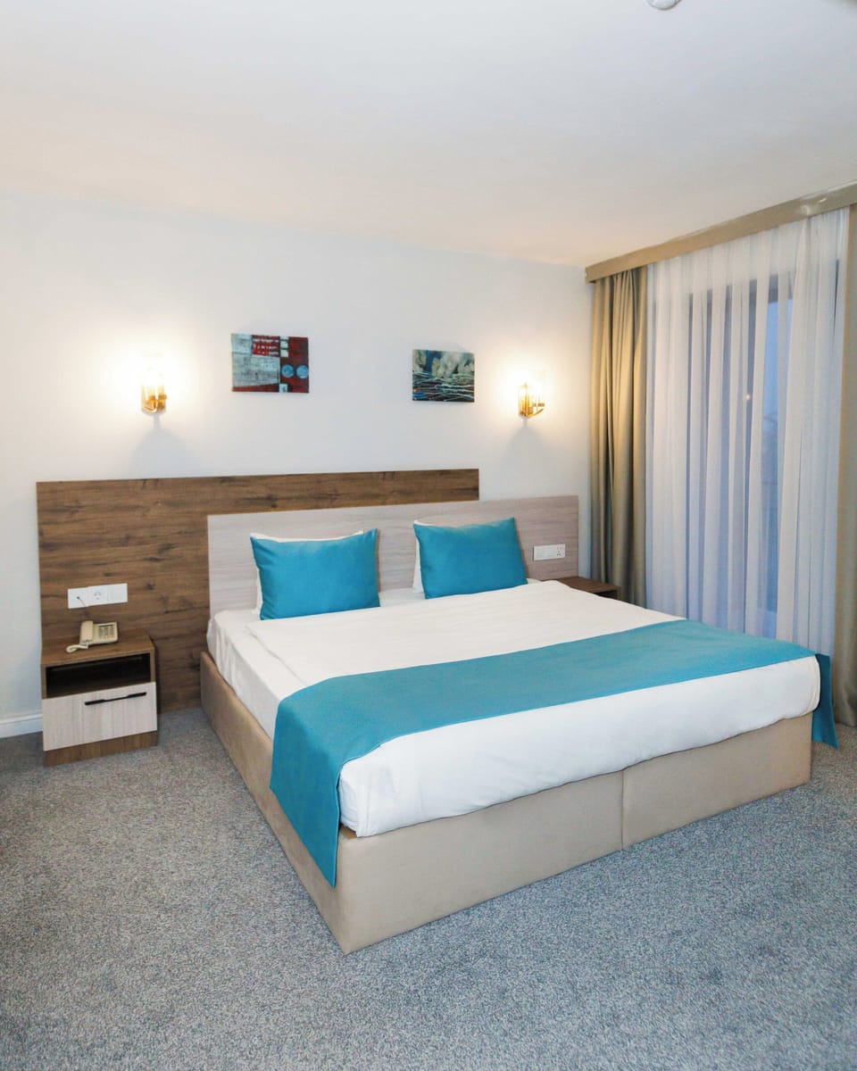 Deluxe Double Room, Balcony, City View | In-room safe, laptop workspace, iron/ironing board (on request)