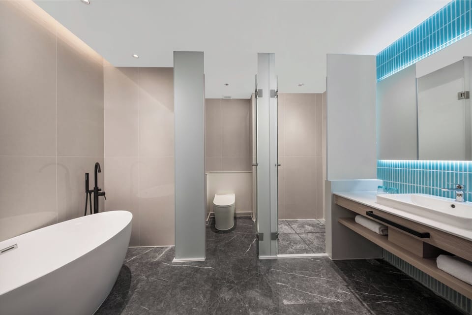 1 Bedroom Suite | Bathroom | Hair dryer, slippers, towels, shampoo