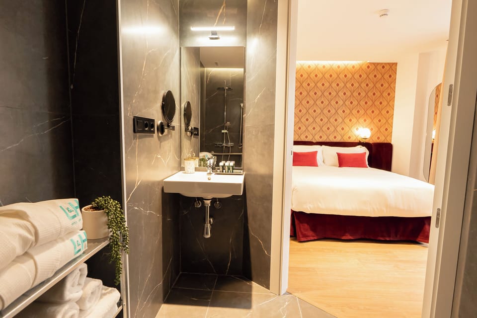 Deluxe Double Room, Accessible | Bathroom | Hair dryer, slippers, towels, soap