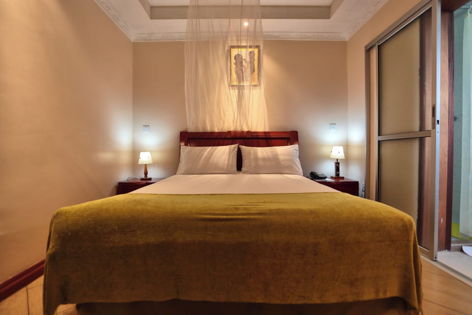 Deluxe Suite, Balcony, Garden View | 1 bedroom, desk, laptop workspace, blackout drapes