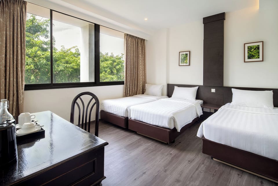 Triple Room, City View | Minibar, in-room safe, desk, laptop workspace