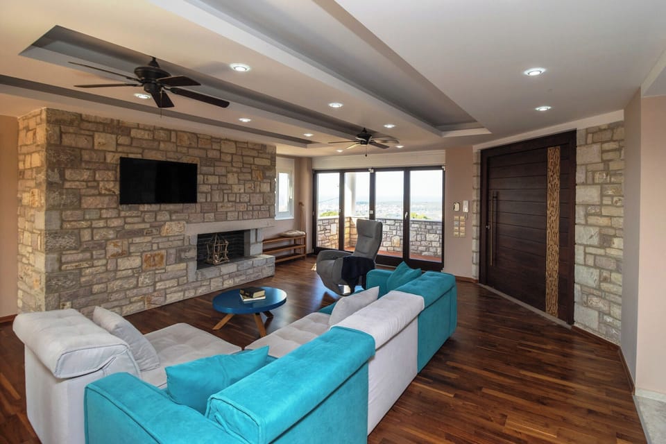 Villa | Living area | TV, fireplace