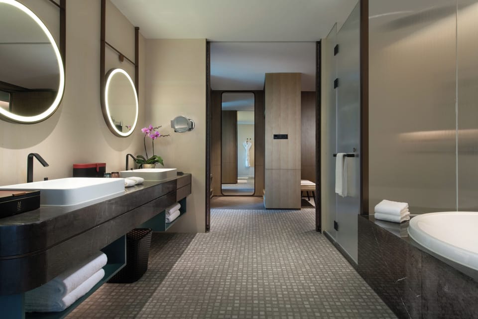 Superior Suite, M Lounge Access, 1 King Size Bed, City View | Bathroom | Separate tub and shower, rainfall showerhead, hair dryer, bathrobes
