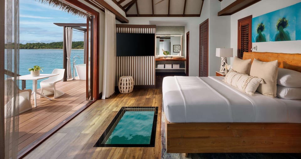 Honeymoon Room, 1 Bedroom, Ocean View (Blue Mahoe Overwater Butler Villa) | Minibar, in-room safe, blackout drapes, iron/ironing board