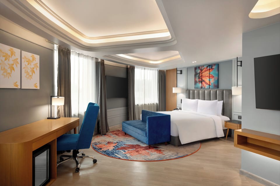Premium Suite, 1 King Bed, City View | Hypo-allergenic bedding available, down comforters, in-room safe, desk