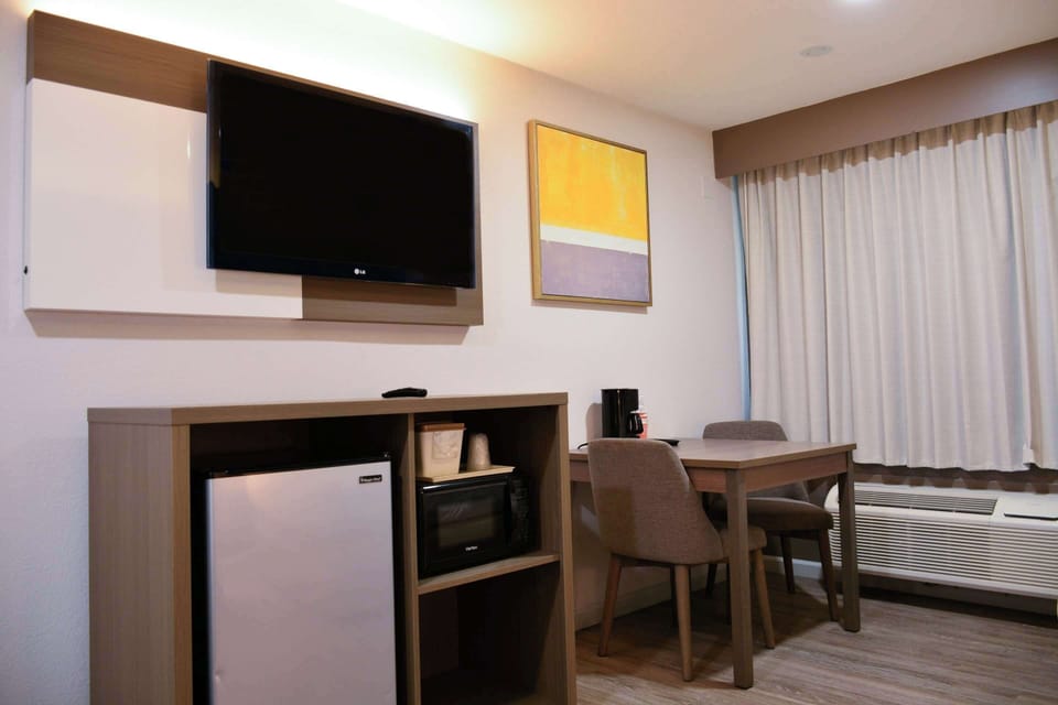 Desk, laptop workspace, blackout drapes, iron/ironing board