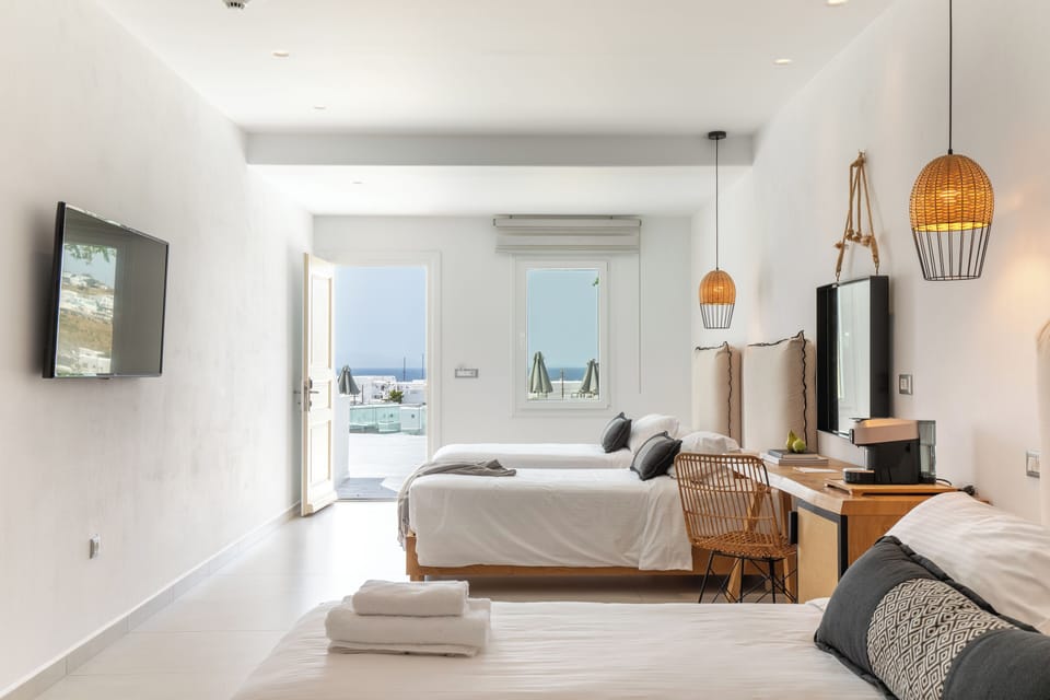 Deluxe Quadruple Room, 1 Bedroom, Sea View | Premium bedding, in-room safe, desk, laptop workspace