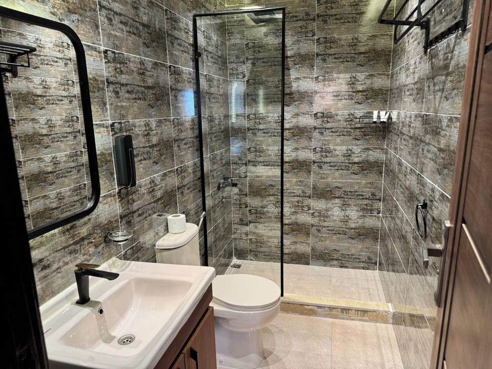 Separate tub and shower, hydromassage showerhead, designer toiletries