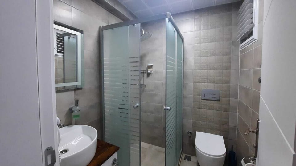 Shower, hair dryer, slippers, towels
