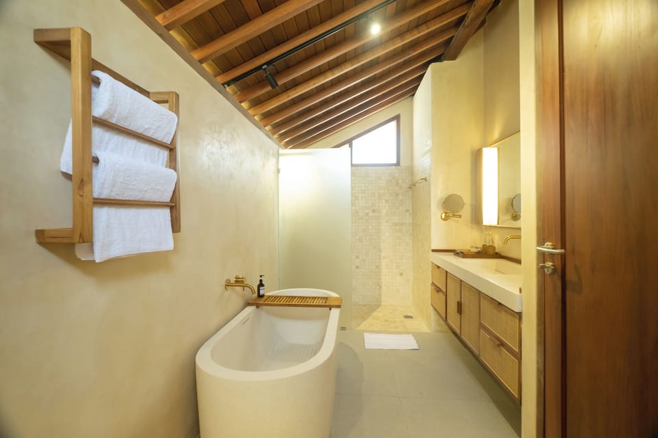 Suite, 1 Queen Bed | Bathroom | Separate tub and shower, free toiletries, hair dryer, slippers