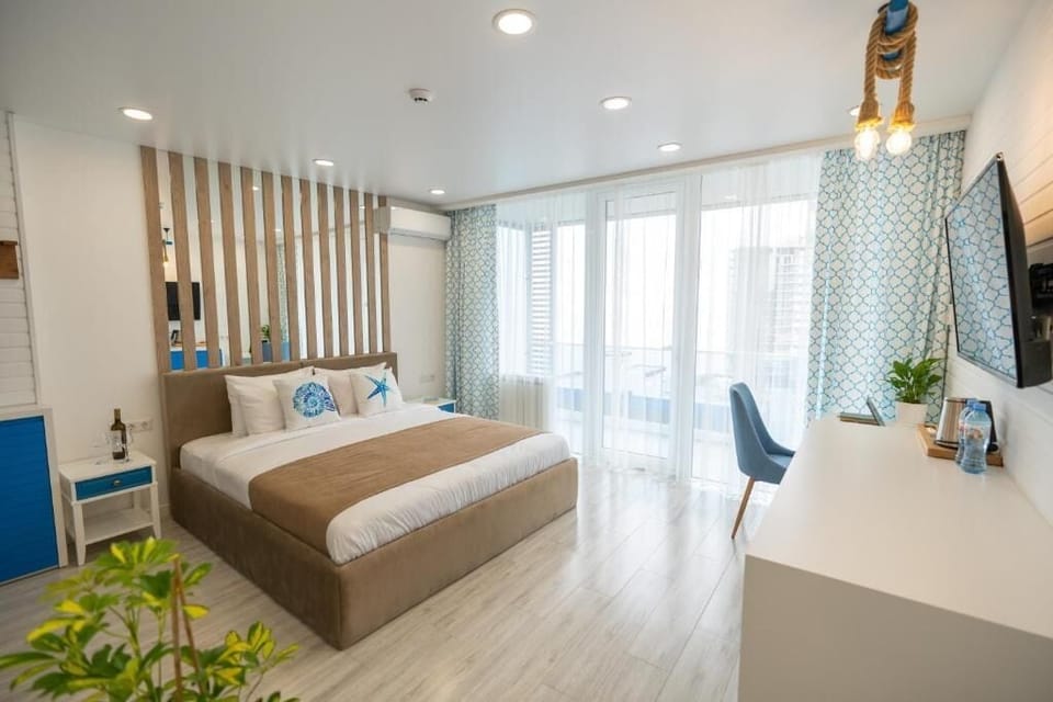 Deluxe Double Room, Balcony, Partial Sea View | Minibar, iron/ironing board, bed sheets