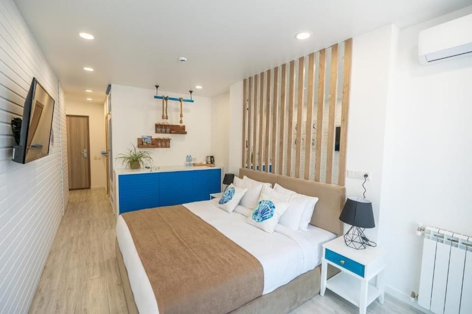 Economy Double Room, Partial Sea View | Minibar, iron/ironing board, bed sheets
