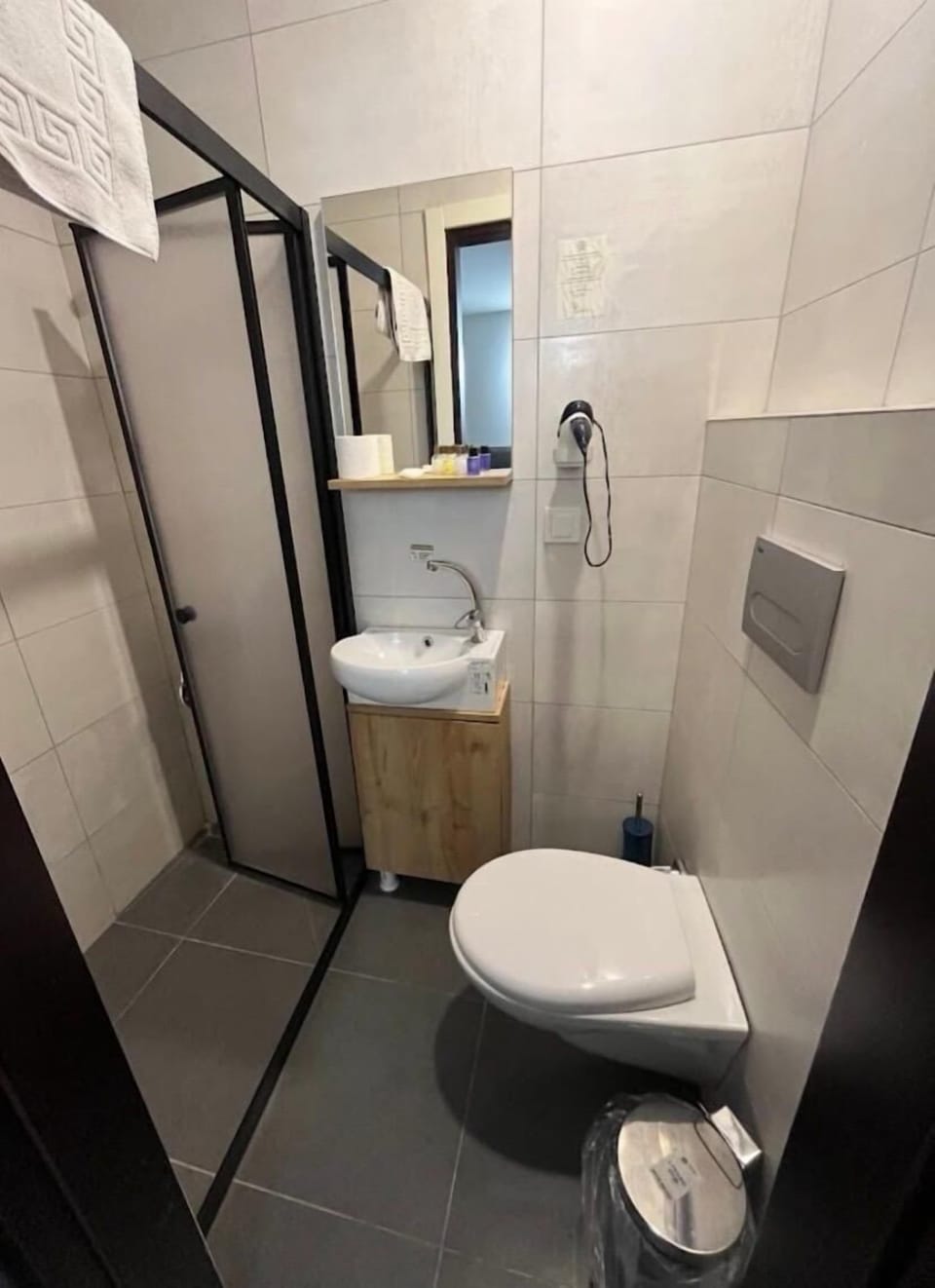 Shower, hair dryer, slippers, towels