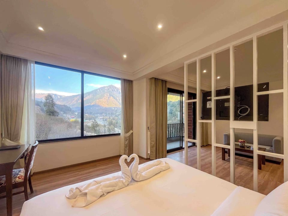 Deluxe Suite, Balcony, Mountain View | Desk, laptop workspace, soundproofing, iron/ironing board
