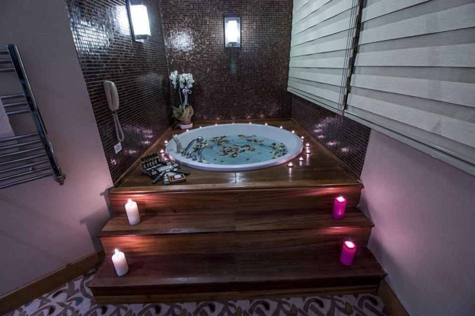 Small Large Suite | Bathroom | Shower, hair dryer, slippers, towels