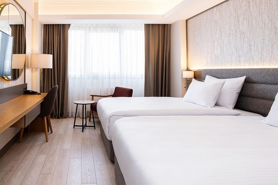 Classic Twin Room, City View | Free minibar items, in-room safe, desk, laptop workspace