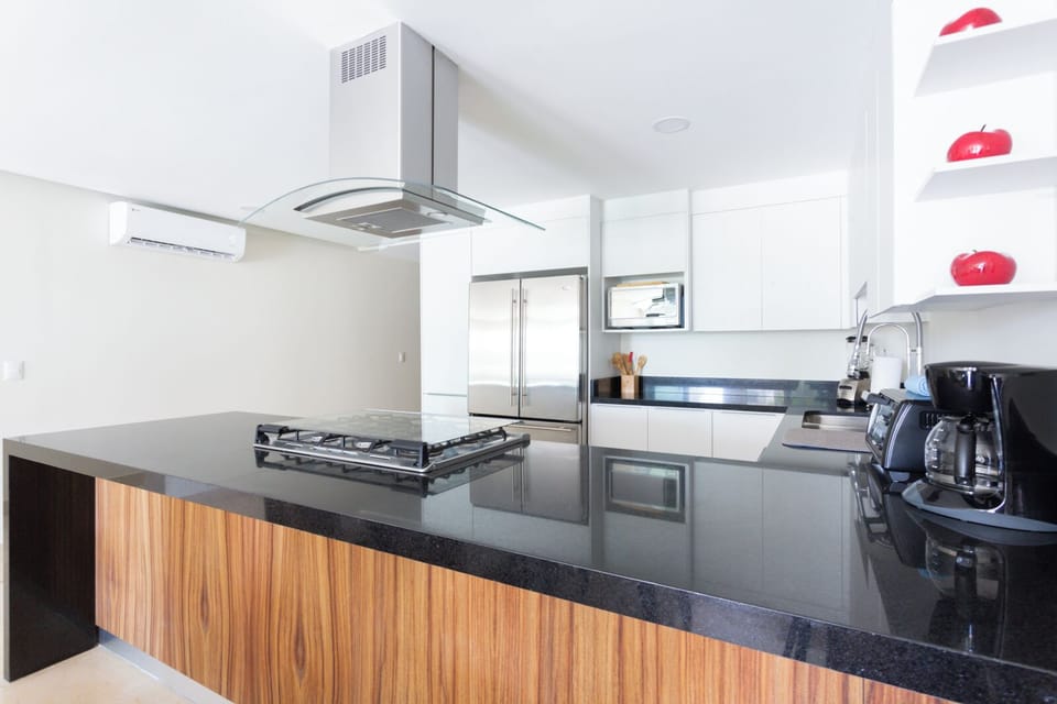 Apartment, Balcony, Pool View | Private kitchen | Full-size fridge, stovetop, coffee/tea maker, blender