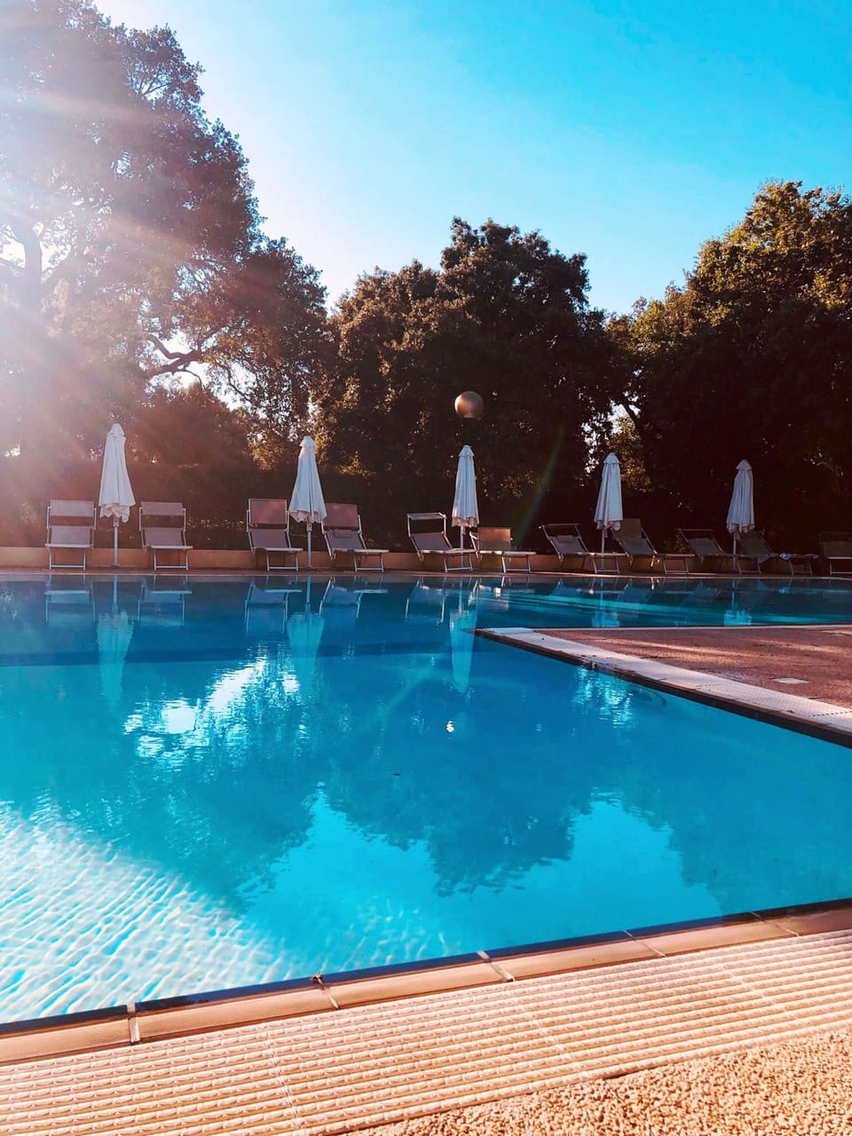Seasonal outdoor pool, open 9:30 AM to 7:00 PM, pool umbrellas