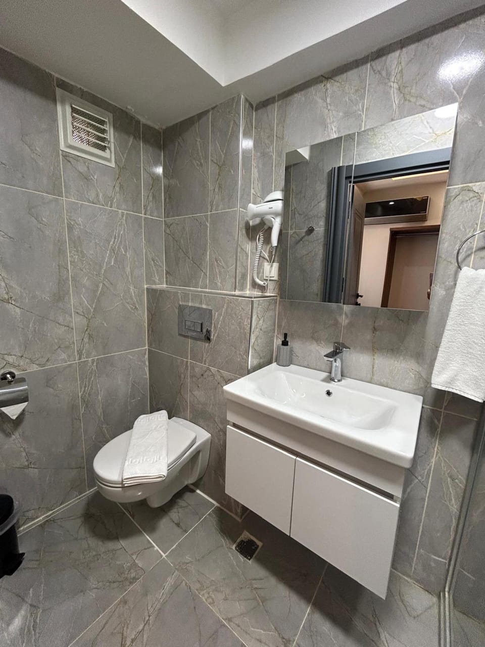 Shower, rainfall showerhead, hair dryer, towels