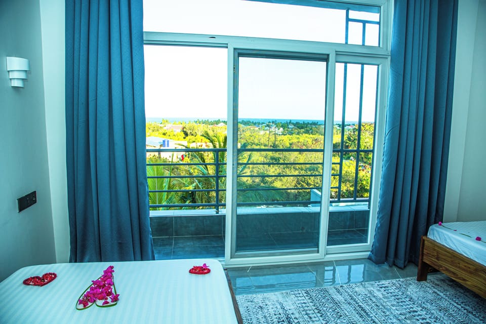 Deluxe Twin Room, Partial Sea View | In-room safe, laptop workspace, blackout drapes, WiFi (free)