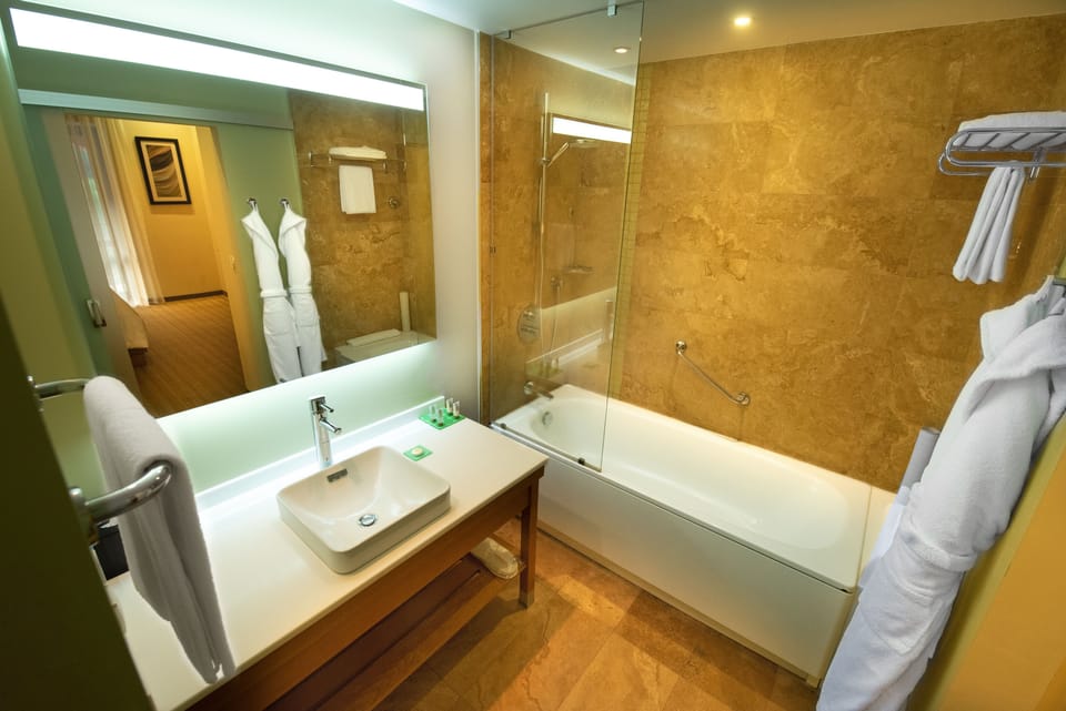 Suite | Bathroom | Designer toiletries, hair dryer, bathrobes, slippers
