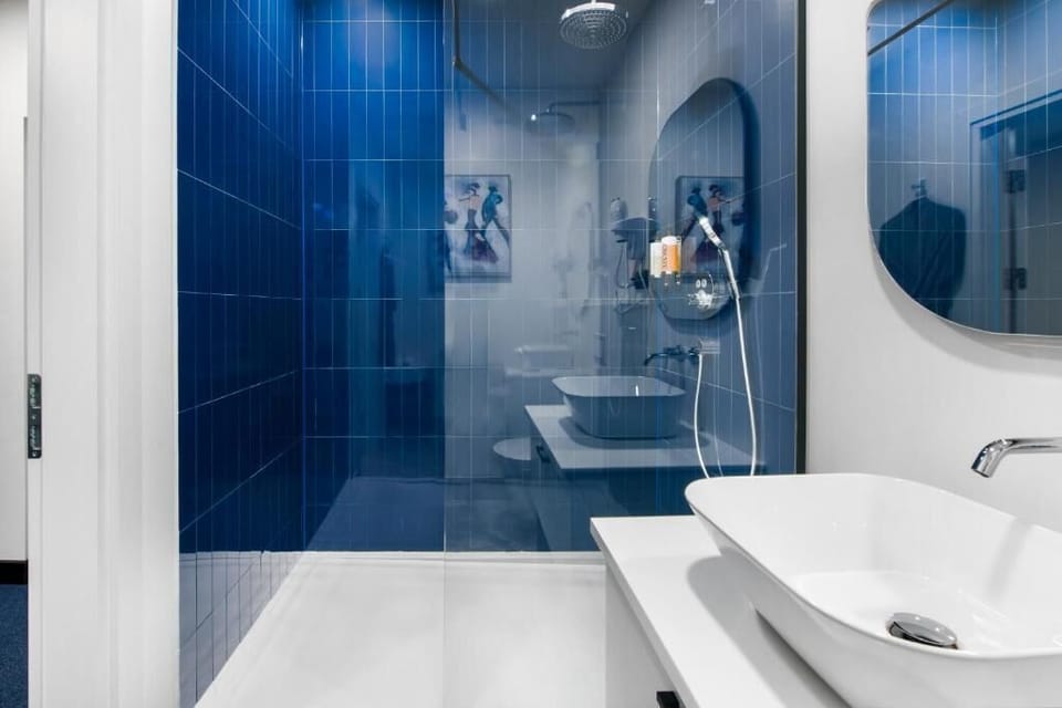 Quadruple Room | Bathroom | Shower, rainfall showerhead, hair dryer, slippers