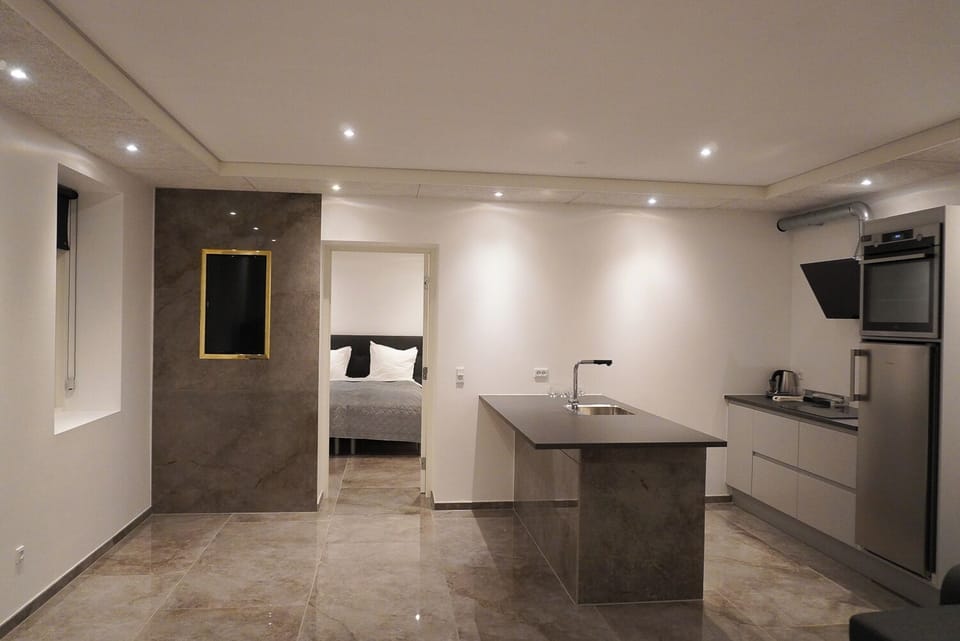Luxury Suite | Private kitchen | Fridge, oven, highchair