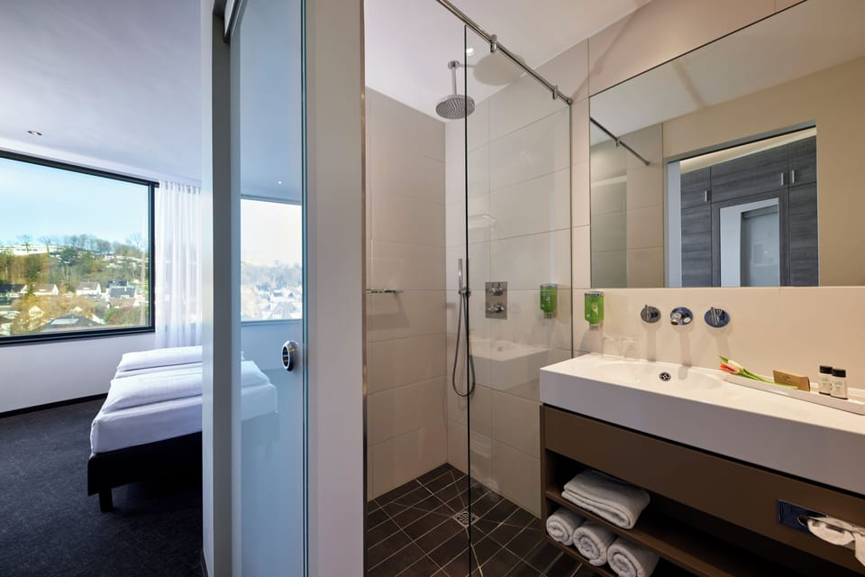 Shower, rainfall showerhead, hair dryer, towels