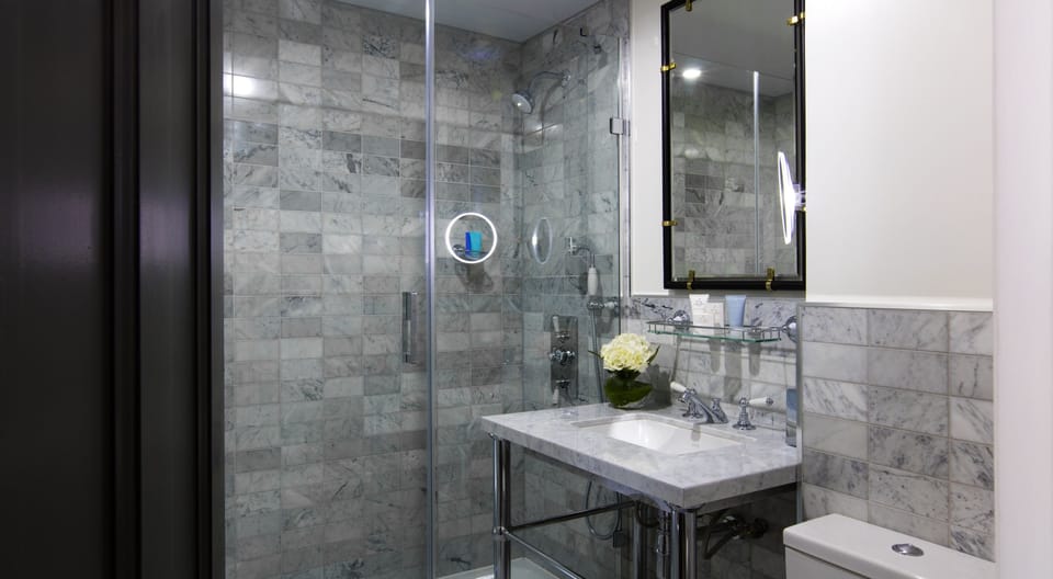 Shower, designer toiletries, hair dryer, bathrobes